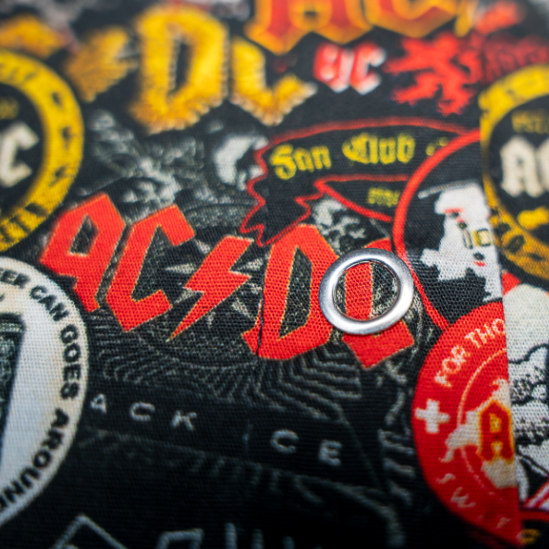 Close-up of a high-quality crop top from AC/DC. It is printed with lots of AC/DC patches. Not cheap merchandise, but high quality. 