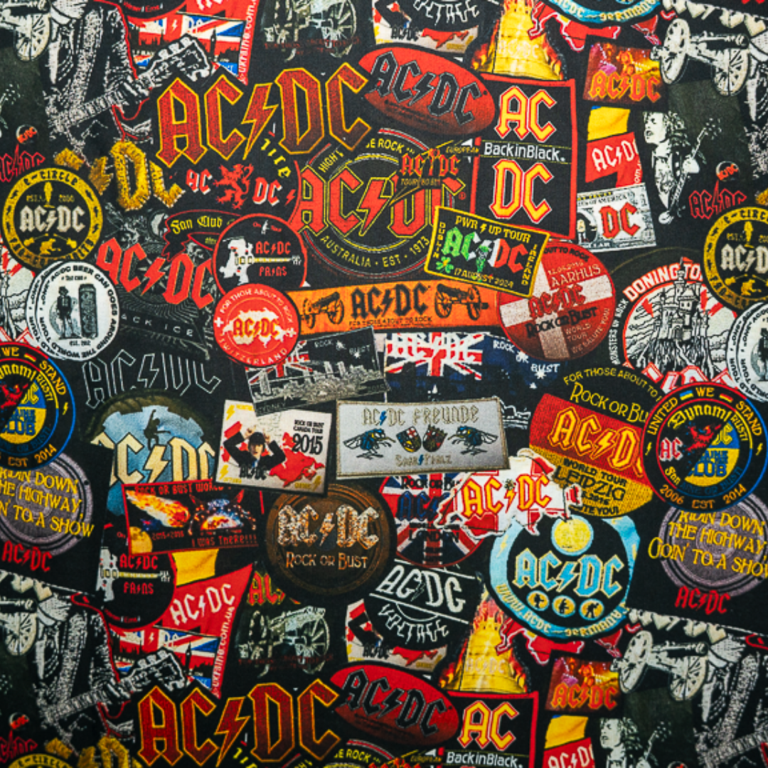 Close-up of a high-quality shirt from AC/DC. It is printed with many AC/DC patches. Not cheap merchandise, but high quality. 