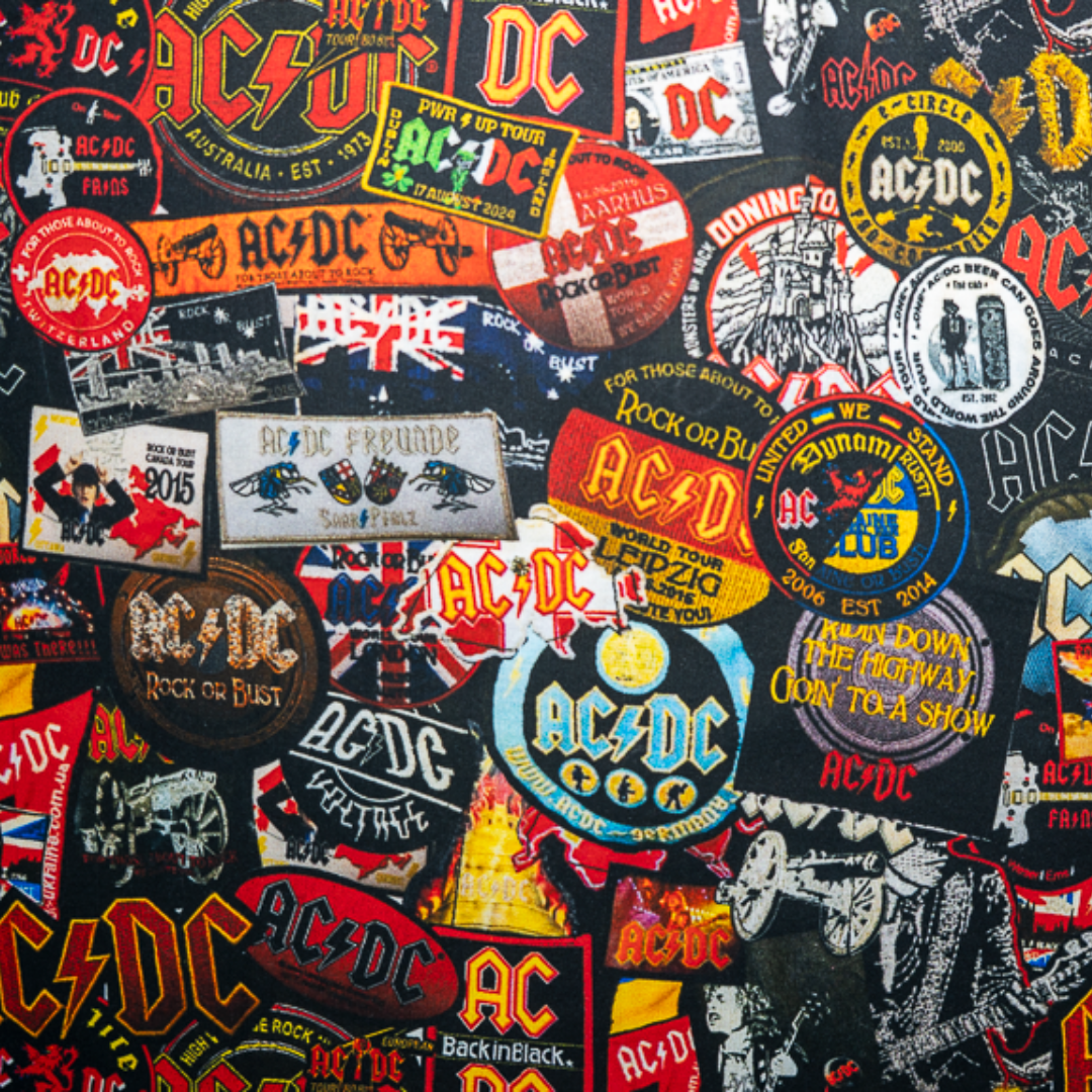 Close-up of a high-quality crop top from AC/DC. It is printed with lots of AC/DC patches. Not cheap merchandise, but high quality. 