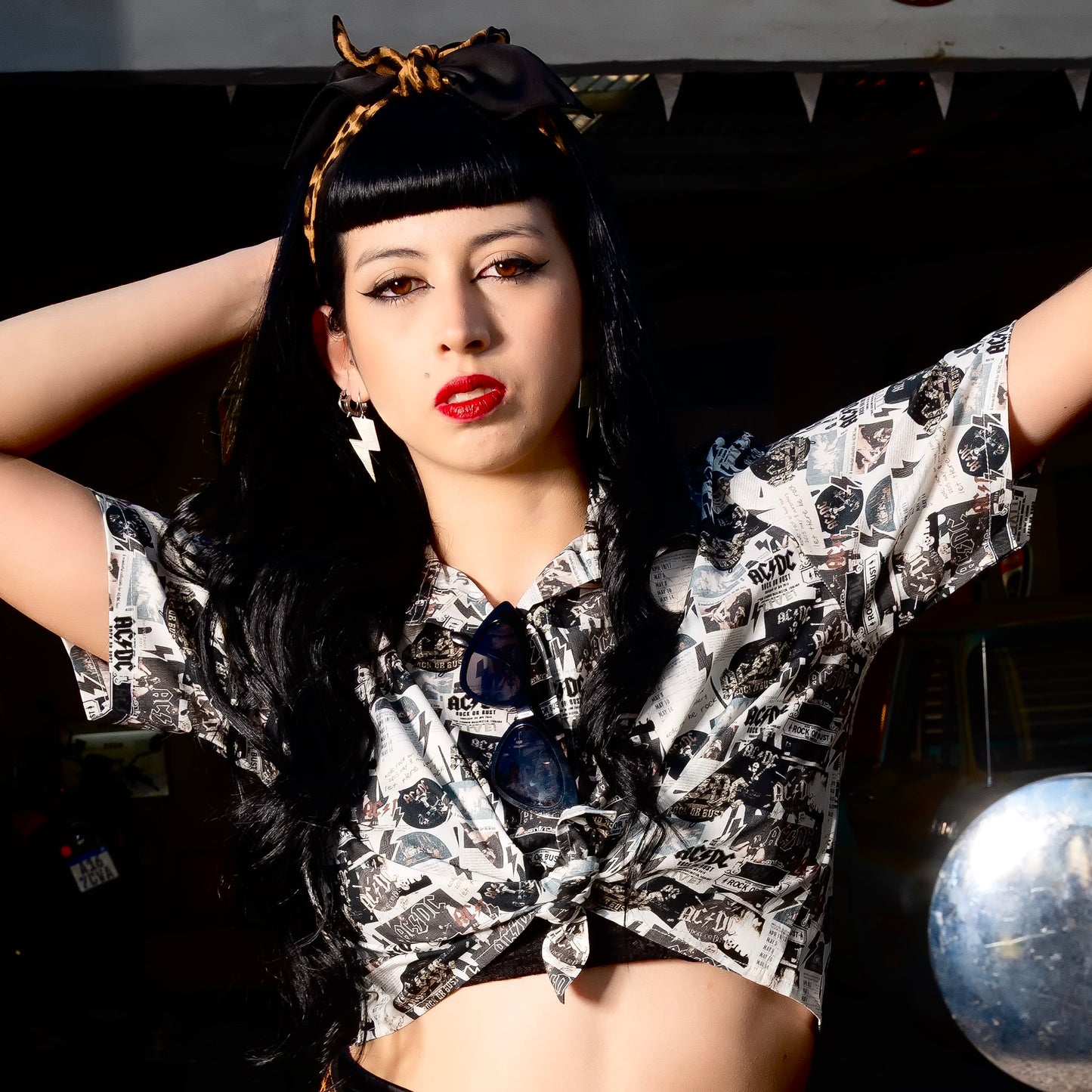 A woman is wearing a high-quality crop top from AC/DC Rock or Bust. Not cheap merchandise, but high quality. 