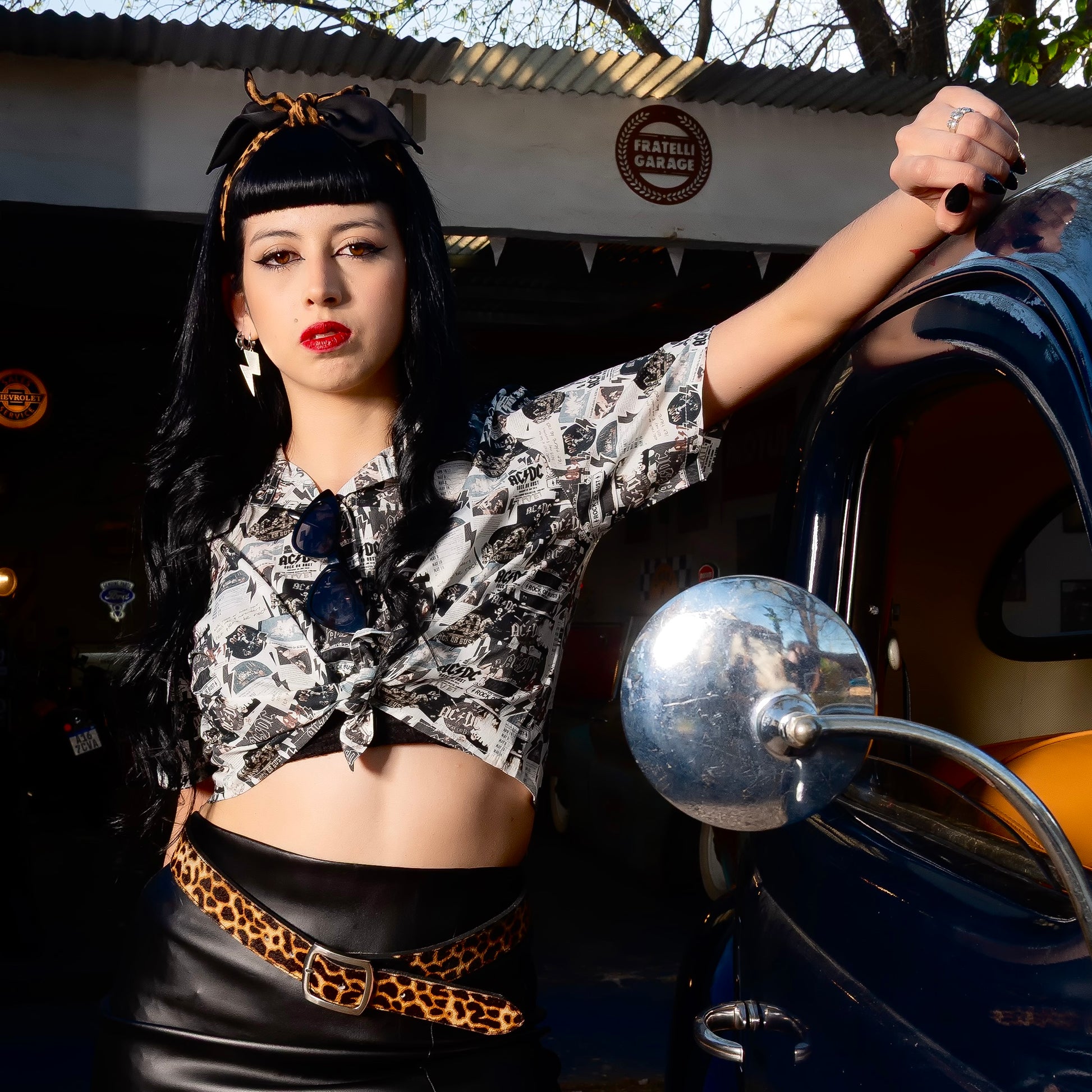 A woman is wearing a high-quality crop top from AC/DC Rock or Bust. Not cheap merchandise, but high quality. 