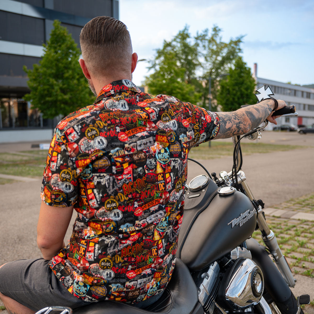 Back view of a high-quality AC/DC shirt. It is printed with many AC/DC patches. Not cheap merchandise, but high quality. 