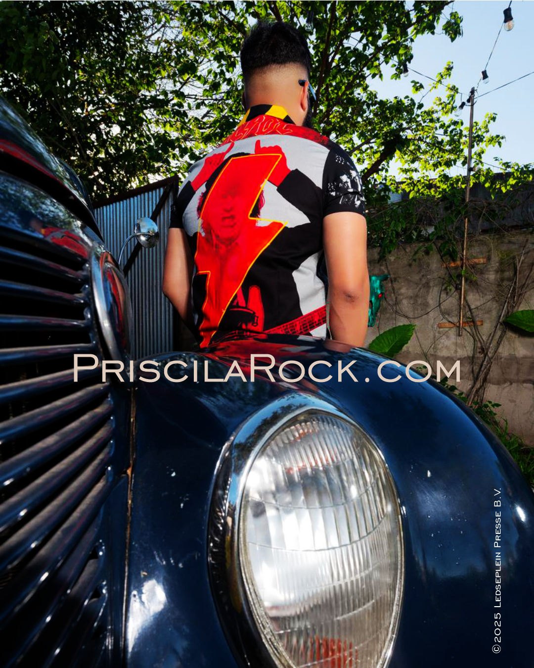 Model wears an AC/DC PWR/UP shirt.